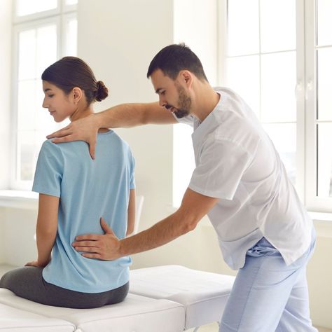 Physiotherapist performing manual therapy for back pain relief in London.